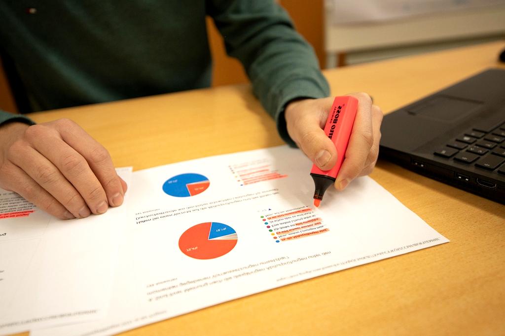 Person typing on laptop with SEO graphs on screen